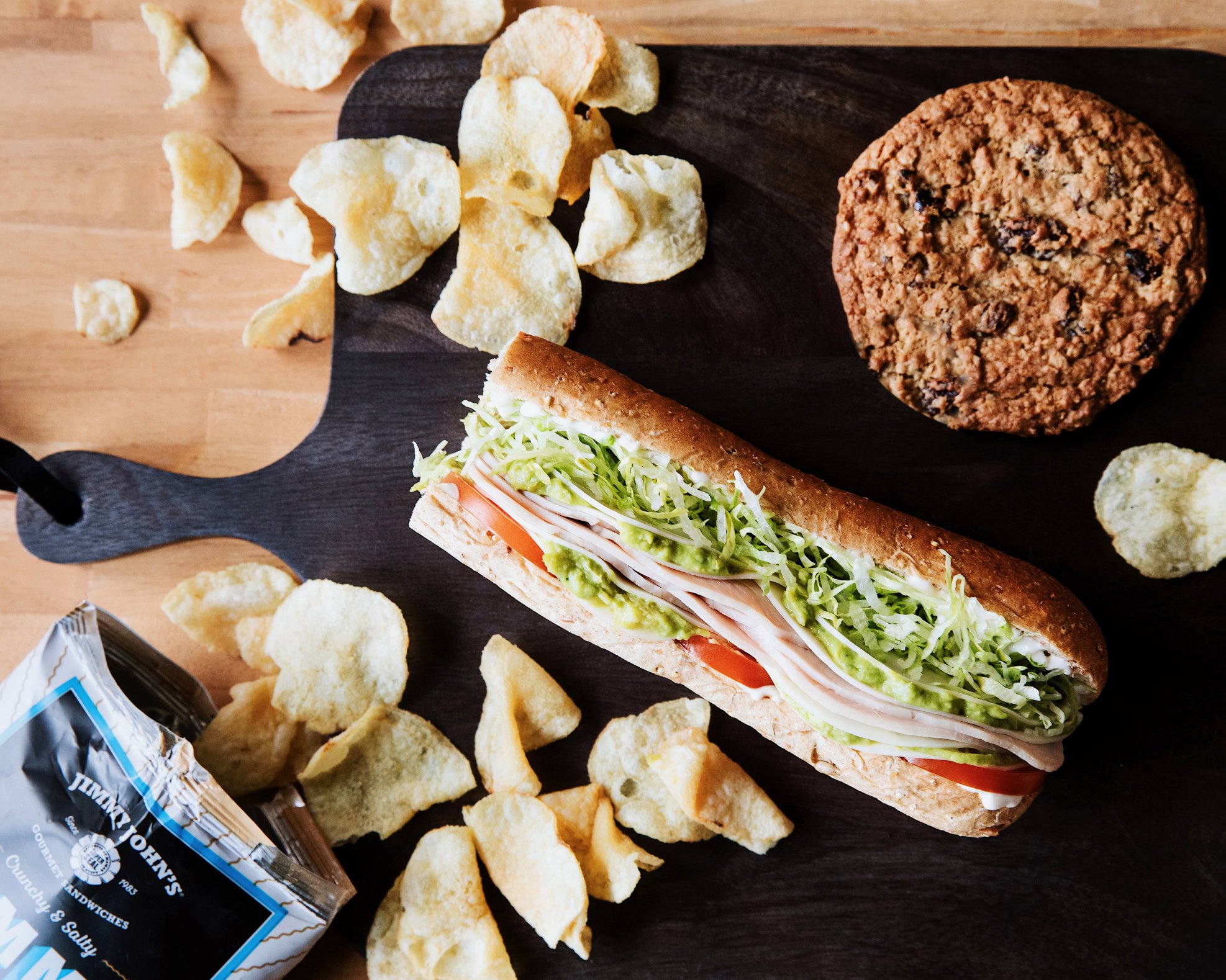 Spread of sandwich cookie and chips on table